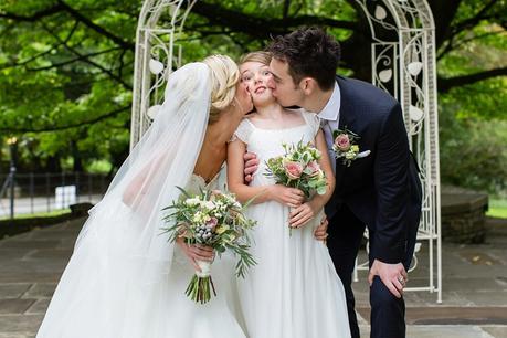 Bride & Groom kiss daughter at crow hill wedding