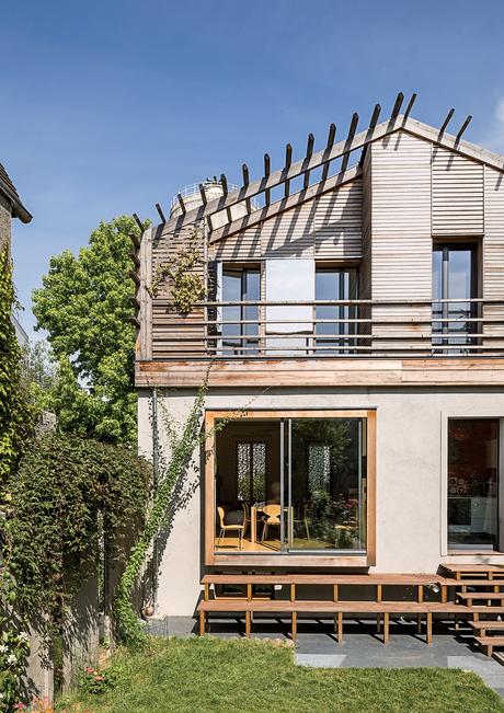 modern prefab home in Paris suburb with Technal sliding doors and windows, wood stairway to garden and concrete and red cedar facade