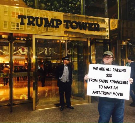 Muslim Michael Moore holding up more signs!