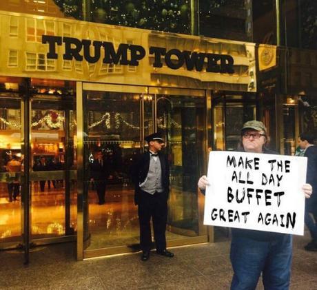 Muslim Michael Moore holding up more signs!