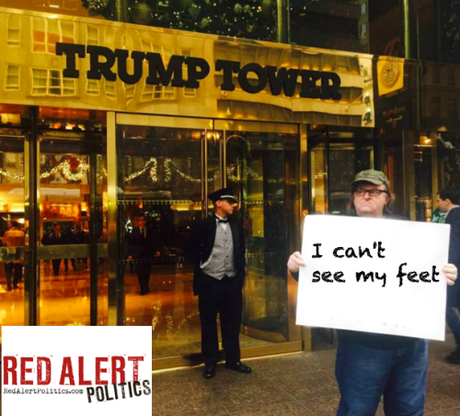 Muslim Michael Moore holding up more signs!