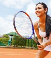 Woman playing tennis and waiting for the service