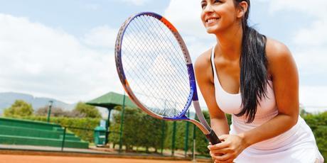 Woman playing tennis and waiting for the service