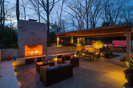 Outdoor living area with a fireplace at a renovated Pennsylvania Colonial