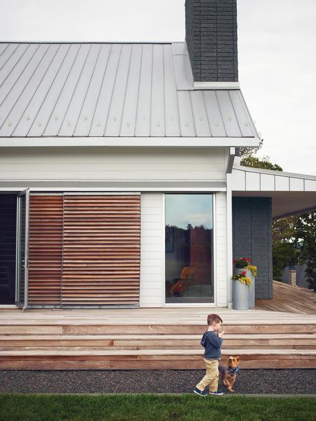 Modern wraparound wooden porch with long steps 
