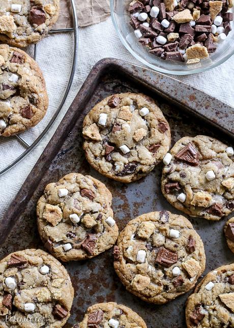 Skip the campfire and whip up a batch of S'mores Cookies! Made with graham cracker cookie dough, chocolate chips & marshmallow bits, these s'mores cookies taste just like your favorite summer treat so you can have s'mores year round.