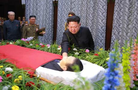 Kim Jong Un touches the embalmed body of WPK Secretary Kim Yang Gon, whilst attending a viewing and wake in Pyongyang on December 30, 2015.  Also seen in attendance (left) are Kim Ki Nam and VMar Hwang Pyong So (Photo: KCNA/Rodong Sinmun).