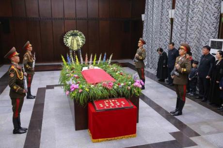 The remains of WPK Secretary for South Korean Affair Kim Yang Gon, attended by a KPA honor guard.  Seen at the foot of his casket are his state titles, awards and watches. (Photo: KCNA/Rodong Sinmun).