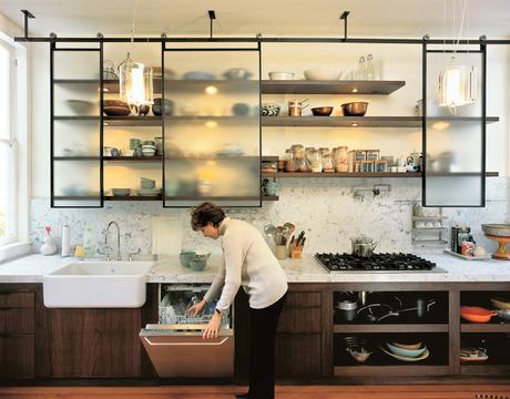 For this San Francisco kitchen remodel, designer Larissa Sand installed custom-built textured glass panels that roll on blackened steel tracks. The translucent finish and back lighting abstract the stored items, creating a clean composition (even when it'