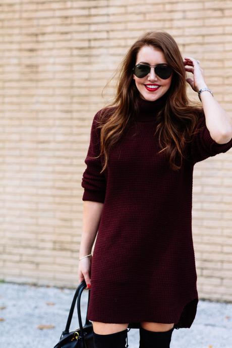 Amy Havins wears a sweater dress and over the knee boots.
