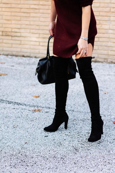 Amy Havins wears a sweater dress and over the knee boots.