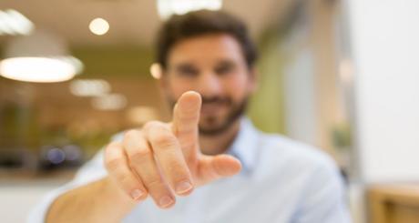 Man hand pushing a digital screen on office background