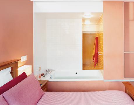 Pink master bedroom with hot tub