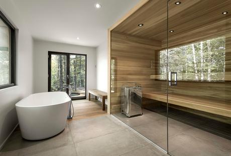 Bathroom with a wood sauna and a freestanding tub