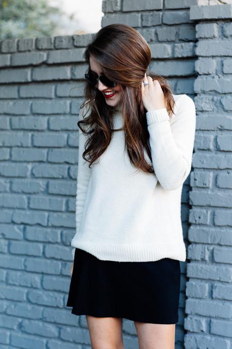 Amy Havins wears a cozy sweater paired with a black skirt and over the knee boots.