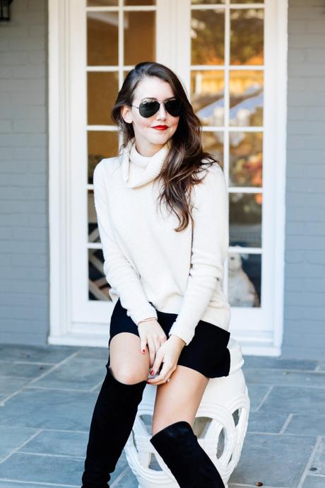 Amy Havins wears a cozy sweater paired with a black skirt and over the knee boots.