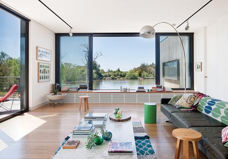modern lakeside home in Australia living room with arco lamp by flos, b&b italia coffee table, and poltroon frau sofa