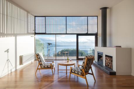 Living room with ocean views in Australian beach home by OLA Studio