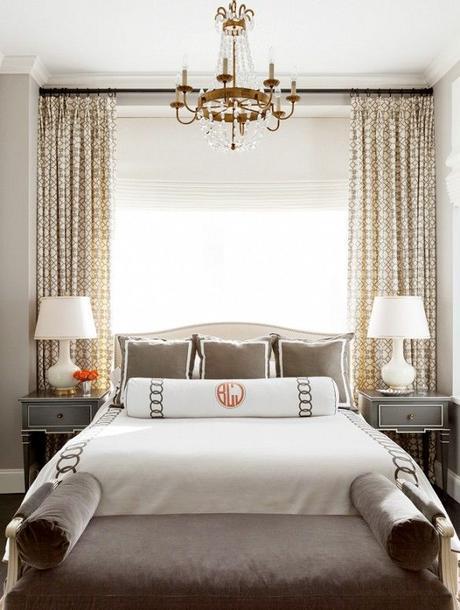 Big open window, white lamps, grey furniture, small chandelier and monogrammed bedding: 