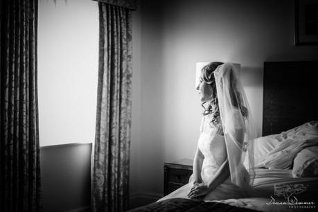 Bride looks out window at Hendon Hall