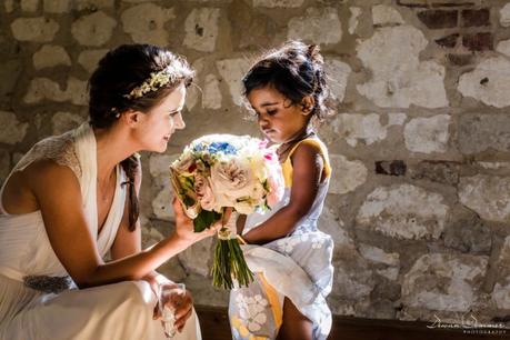 Bride shows girl her bouquet