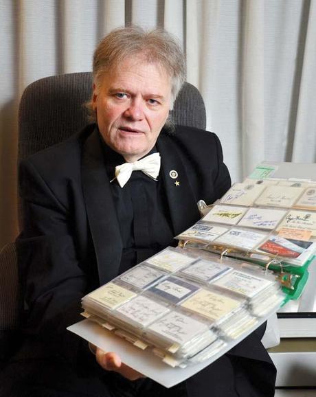 Quite a collection: P. M. (Doc) Koepfer shows off some of the business cards in is collection of 80,000. He's been collecting business cards since the age of six.