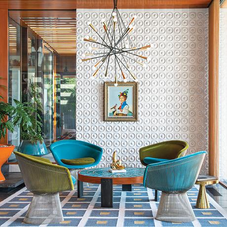 midcentury-inspired living room with Platner chairs and tile wall
