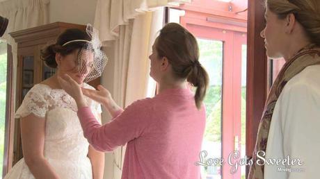 bride getting birdcage veil adjusted