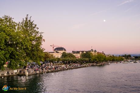 Moon rising over Lake Zurich as the sun sets.