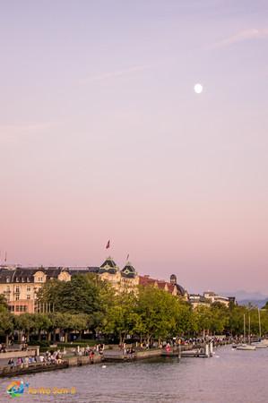 The moon rises as the sun sets, Lake Zurich, Switzerland.