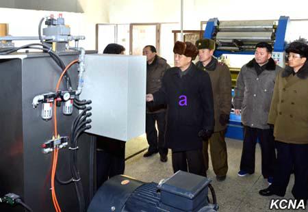 DPRK Premier Pak Pong Ju is briefed about CNC machines during a factory tour (Photo: KCNA).