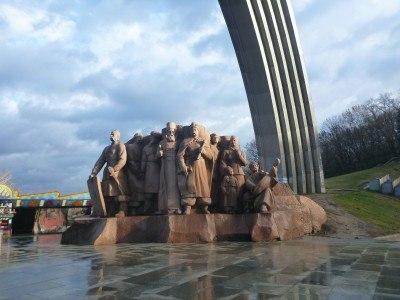 Backpacking in Ukraine: Getting A Free Night Tour of Kiev Soviet monument under the arch.
