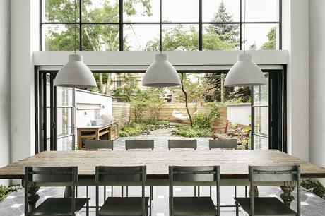 Dining room with sliding doors to garden in Brooklyn renovation by Elizabeth Roberts.