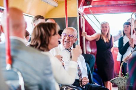 Father of the bride enjoying a joke on the bus