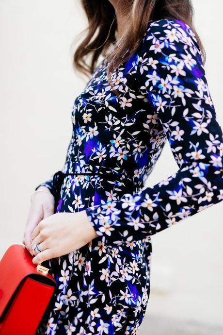 Amy Havins wears a blue floral print Shoshanna dress with Stuart Weitzman over the knee boots.