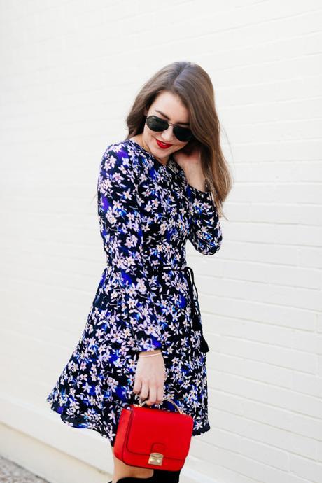 Amy Havins wears a blue floral print Shoshanna dress with Stuart Weitzman over the knee boots.