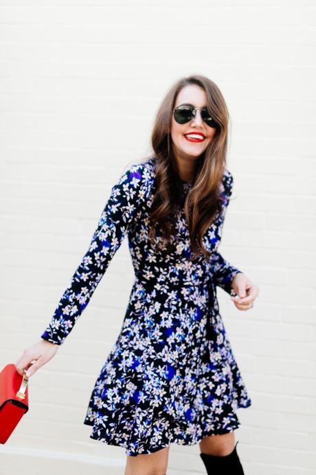 Amy Havins wears a blue floral print Shoshanna dress with Stuart Weitzman over the knee boots.