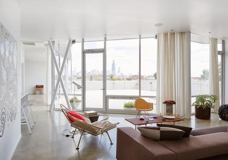Modern prefab Chicago live/work space by UrbanLab with chicago tempered glass windows, tubelite frames, and concrete flooring in the living area