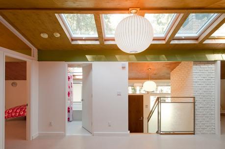 The two twelve-by-sixteen-foot bedrooms, directly above a comparable pair on the first floor, feature a glass transom that follows the pitch of the roof. “The stair and railings were very simple,” Depardon observes. “We added a bit of design, with panels 