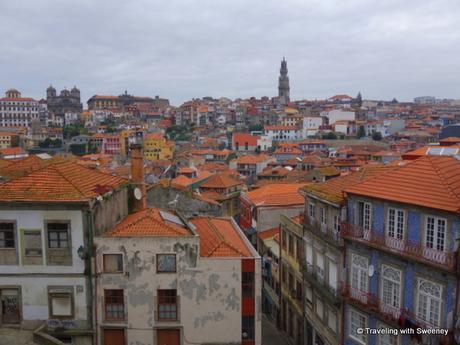 Over the rooftops of the colorful buildings of Porto, the tower of Clérigos Church is visible from many points in the city and surrounding area