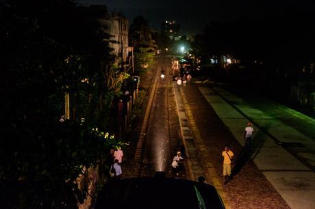 Dehiwala station at night. Lit up by the train, people climb up and down the station to get to the train, or go home. Fascinating scene that unfolded at every station, all the time.