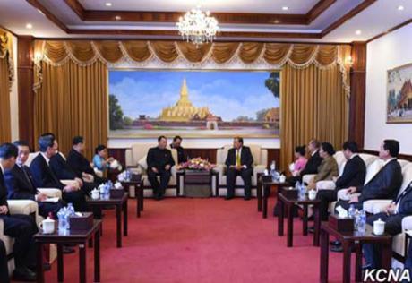 Kim Yong Chol (background, left) meets with Lao People's Revolutionary Party General-Secretary 