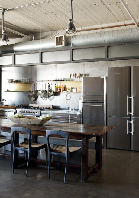 Modern Los Angeles loft kitchen renovation with stainless steel cabinets by Fagor, Henry Hall Designs chairs, CB2 benches and farm table