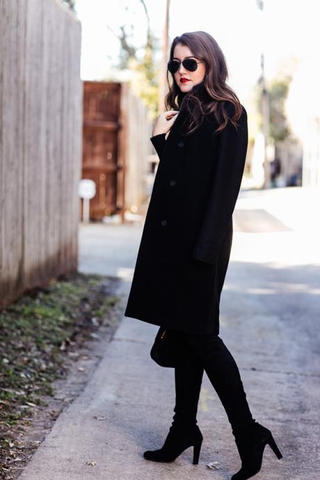 Amy Havins wears an all black look paired with faux leather leggings.