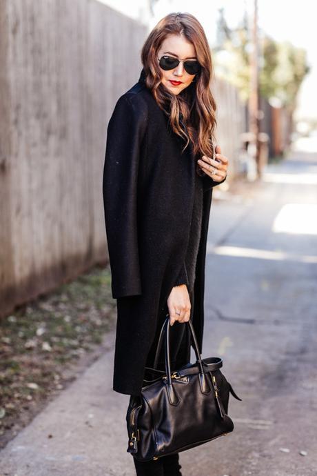 Amy Havins wears an all black look paired with faux leather leggings.