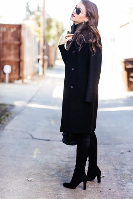 Amy Havins wears an all black look paired with faux leather leggings.