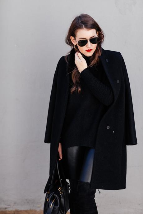 Amy Havins wears an all black look paired with faux leather leggings.