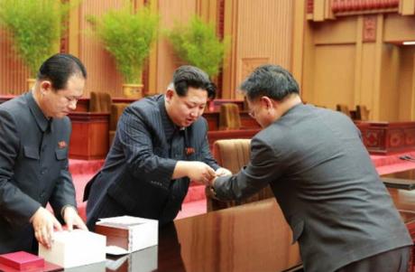 Kim Jong Un presents an award to a DPRK space scientist in Pyongyang on February 17, 2016.  Also in attendance (left) is Hyon Yong Chil, deputy director of the WPK Machine-Building Industry (defense industry) Department (Photo: Rodong Sinmun).