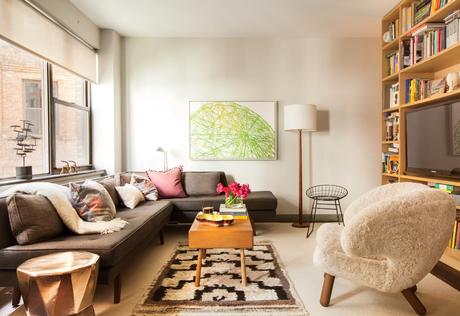 Small modern New York City studio with dunbar sofa, Finn Juhl pelican chair, wire, chair, and BDDW coffee table in the living area