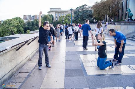 Posing for a picture with the Eiffel tower.